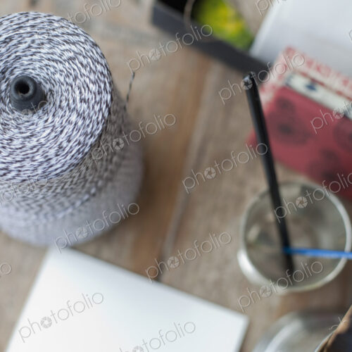 A table top with a small group of objects. Tankard and pencils, paper and a large ball… A table top with a small group of objects. Tankard and pencils, paper and a large ball…