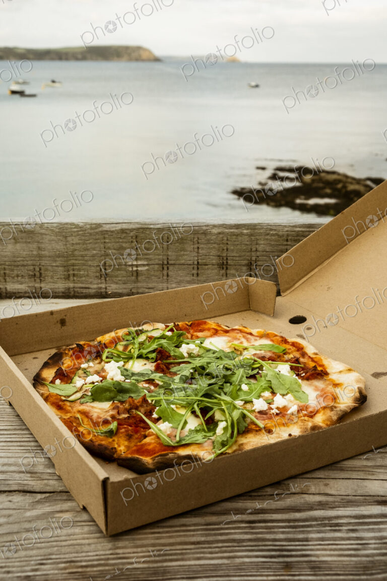 A takeaway pizza in a brown box.