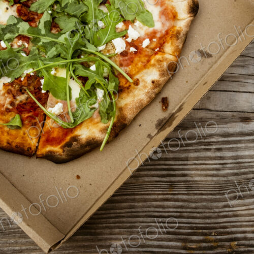 A takeaway pizza in a brown box.