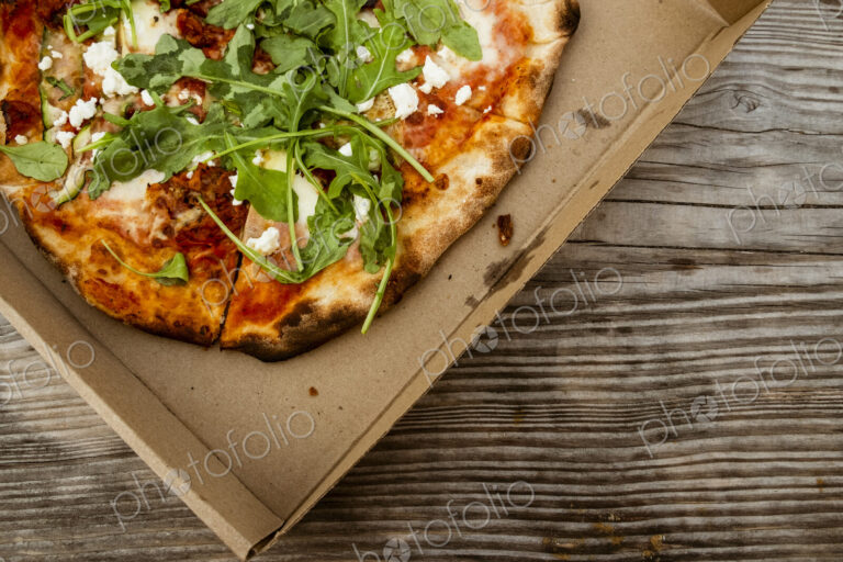 A takeaway pizza in a brown box.