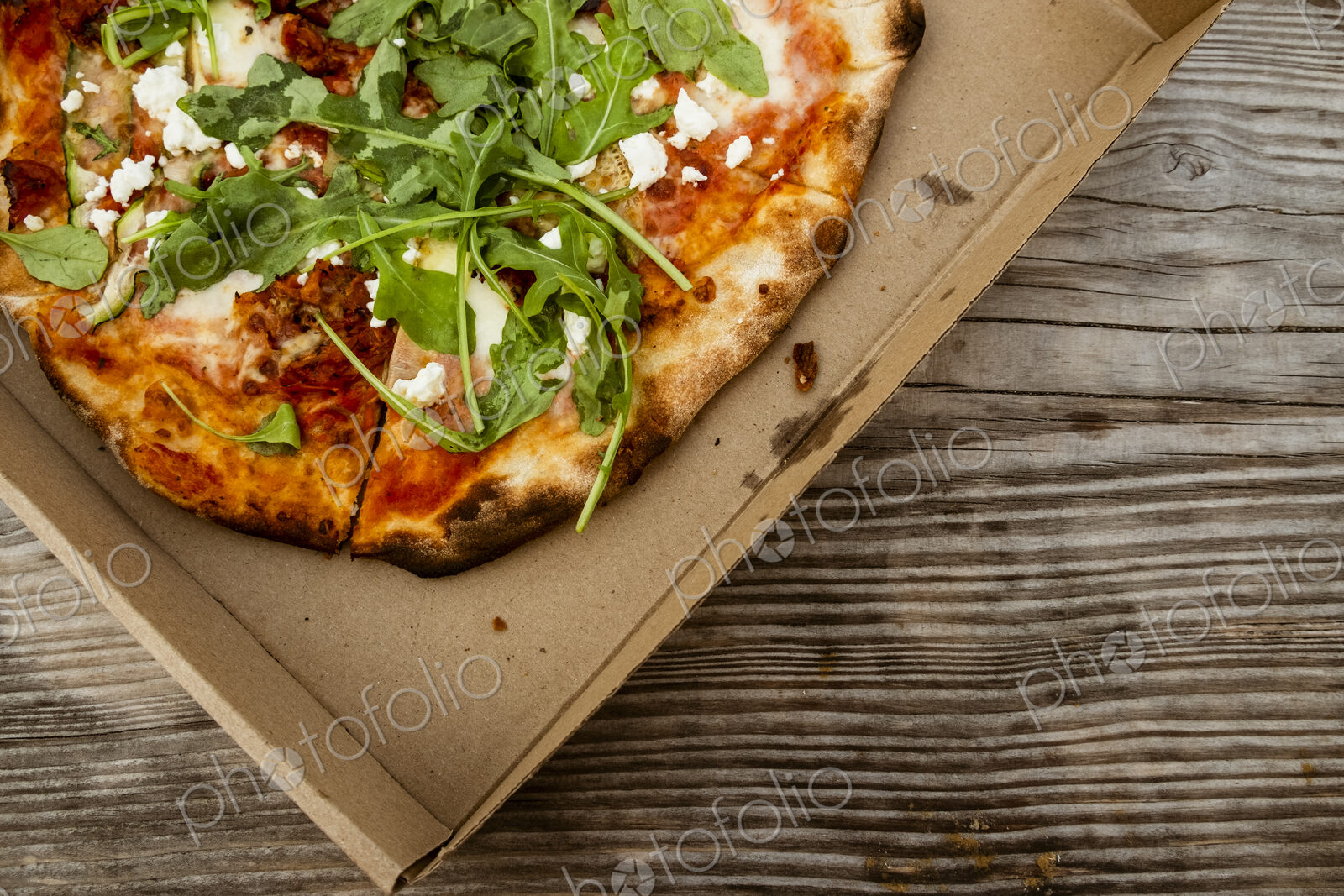 A takeaway pizza in a brown box.
