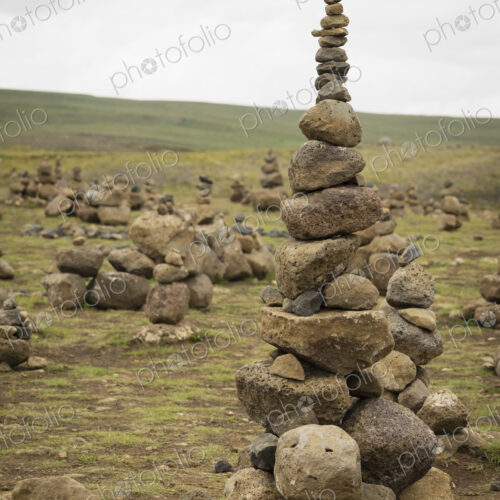 A tall rock cairn made by hikers to mark a spot on a walking path. A tall rock cairn made by hikers to mark a spot on a walking path.