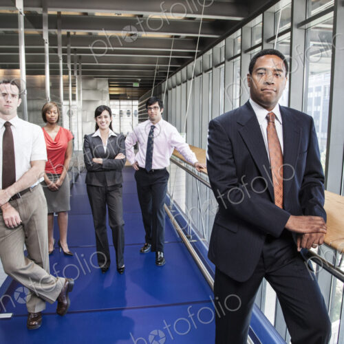 A team of men and women, an ethnically diverse team of business people in the lobby of… A team of men and women, an ethnically diverse team of business people in the lobby of…