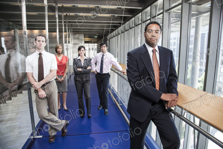 A team of men and women, an ethnically diverse team of business people in the lobby of…