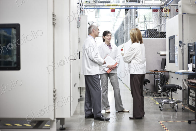 A team of technicians working over a problem in a technical research and development site.