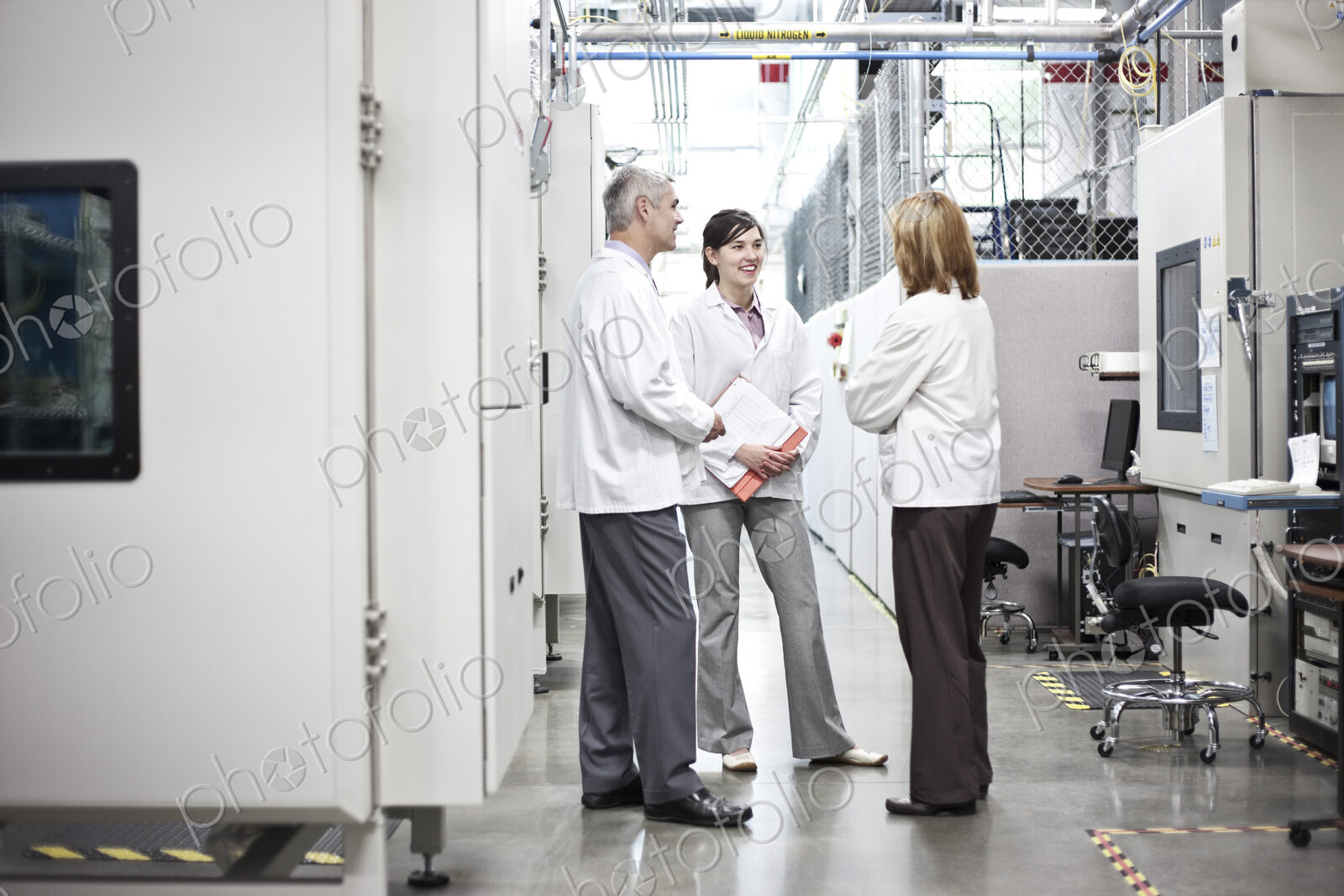 A team of technicians working over a problem in a technical research and development site.