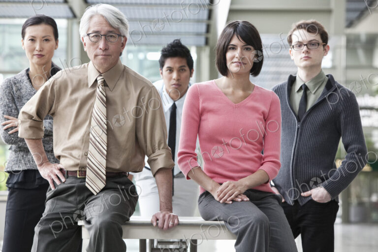A team portrait of a mixed race group of business people with an Asian businessman in…