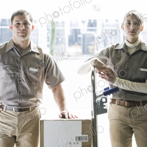 A team portrait of two caucasisn female and hispanic male uniformed warehouse workers . A team portrait of two caucasisn female and hispanic male uniformed warehouse workers .
