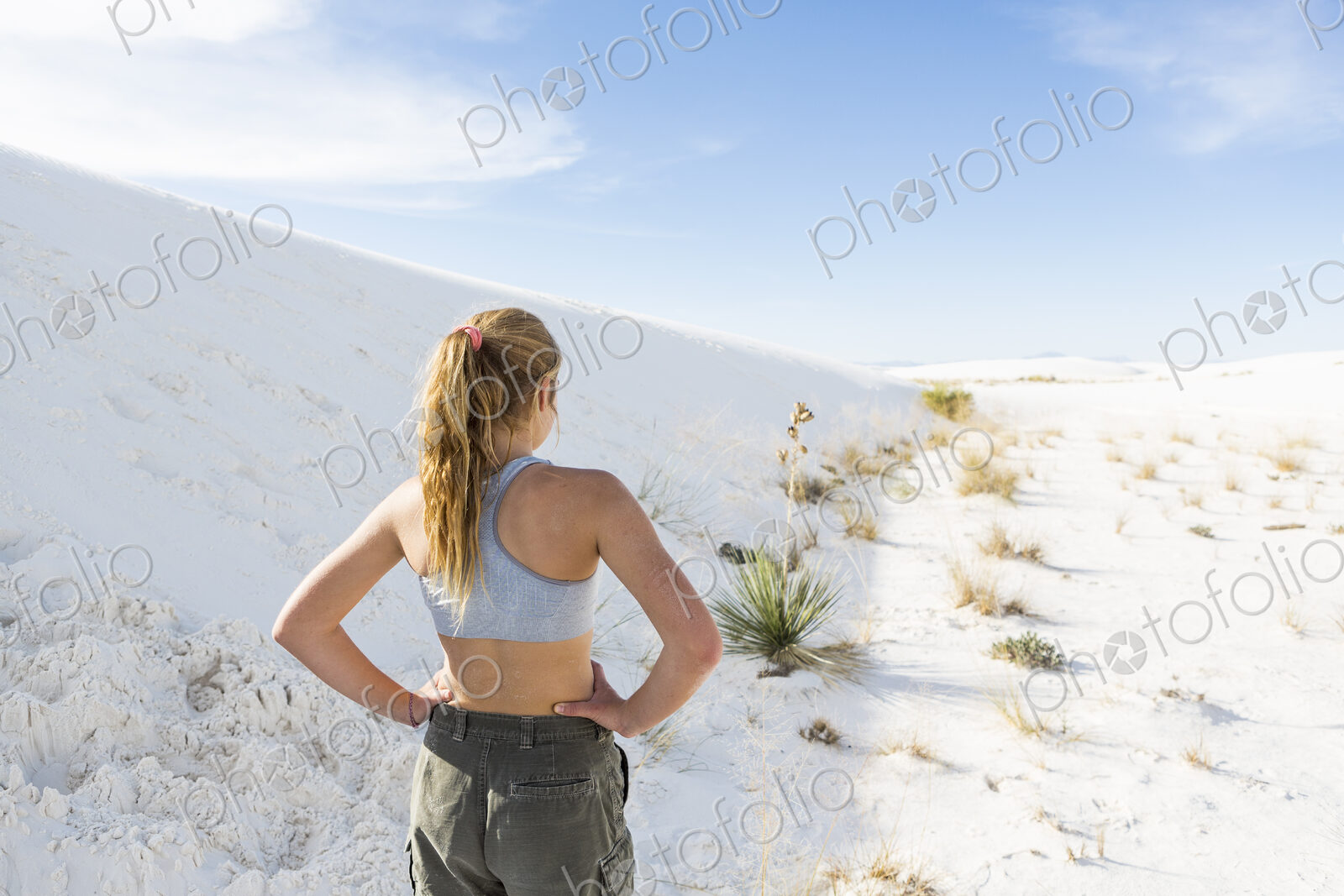 A teenage girl in the open landscape of White Sands Nat’l Monument, NM