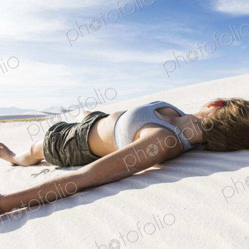 A teenage girl lying on her back on the smooth white sand White Sands Nat'l Monument, NM A teenage girl lying on her back on the smooth white sand White Sands Nat'l Monument, NM