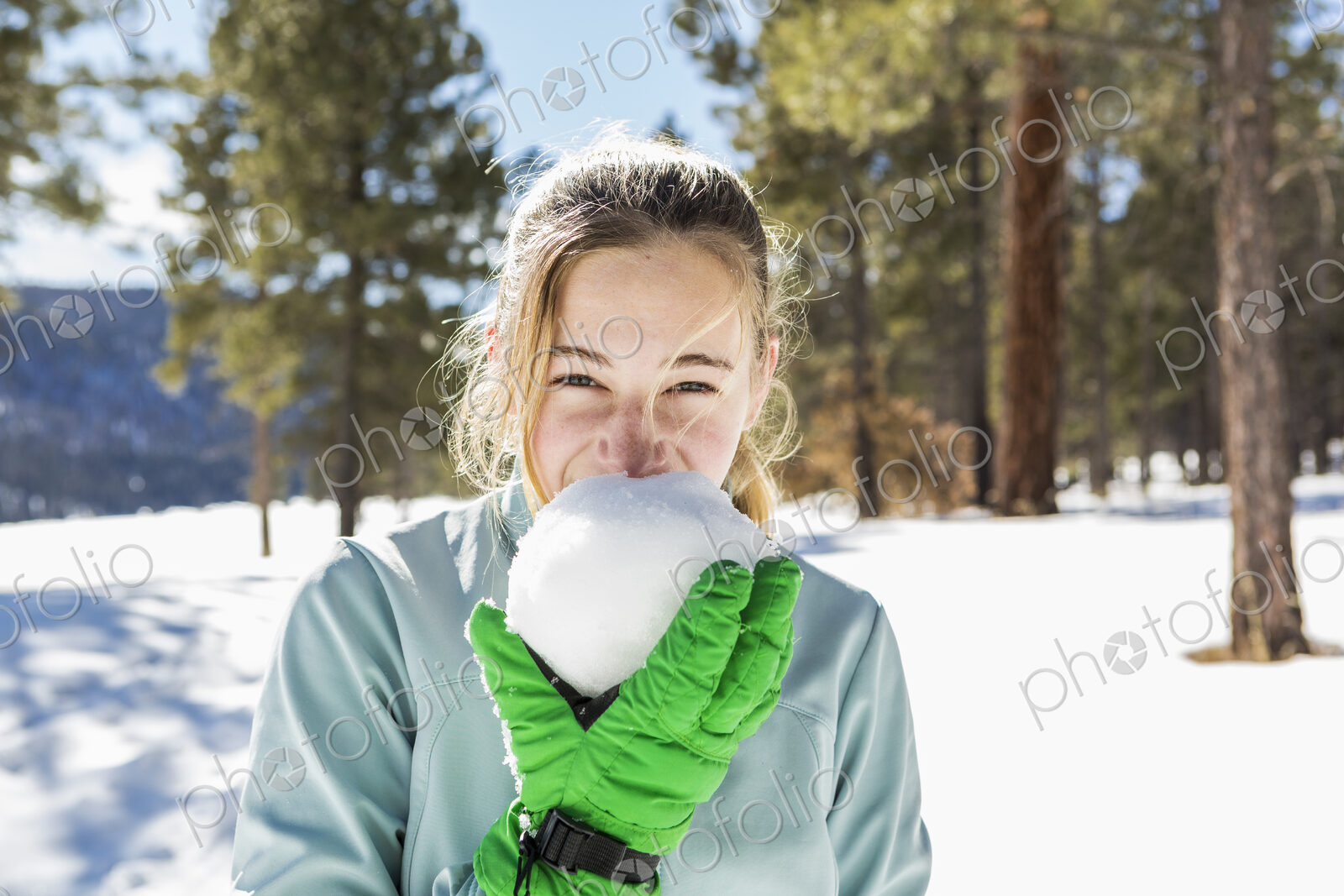 A teenage girl old girl holding and tasting a snowball