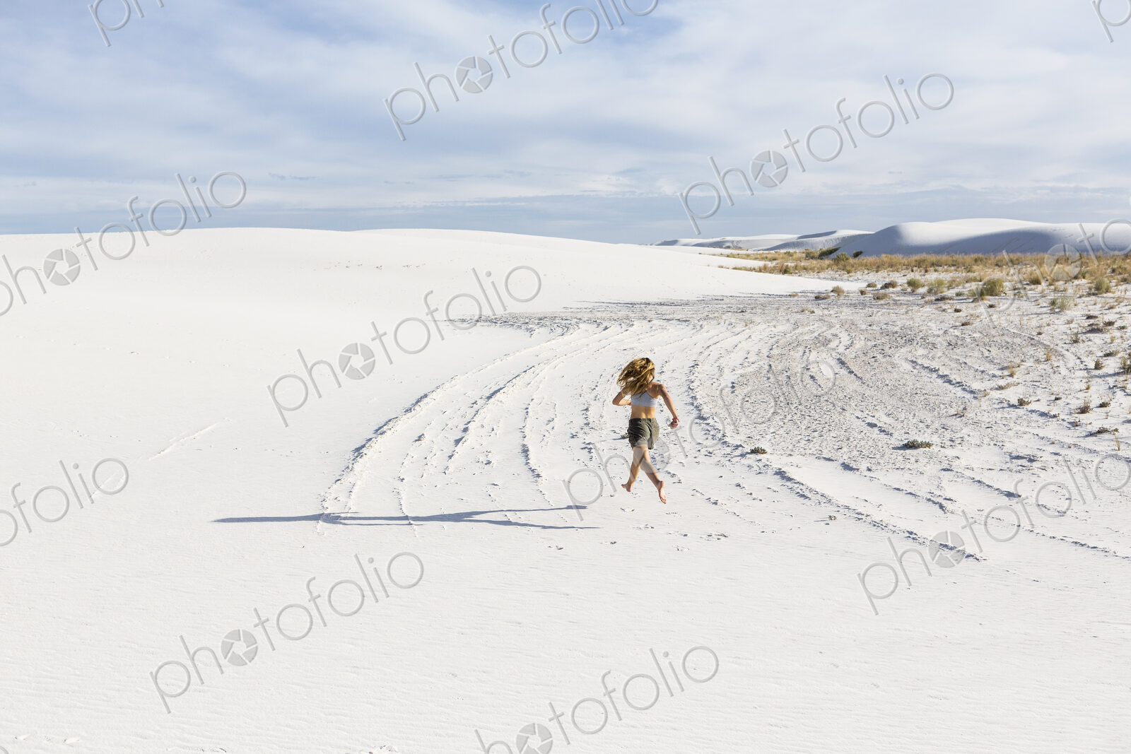 A teenage girl running in the sand, White Sands Nat’l Monument, NM
