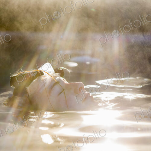 A teenage girl swimming in a pool, steam rising A teenage girl swimming in a pool, steam rising