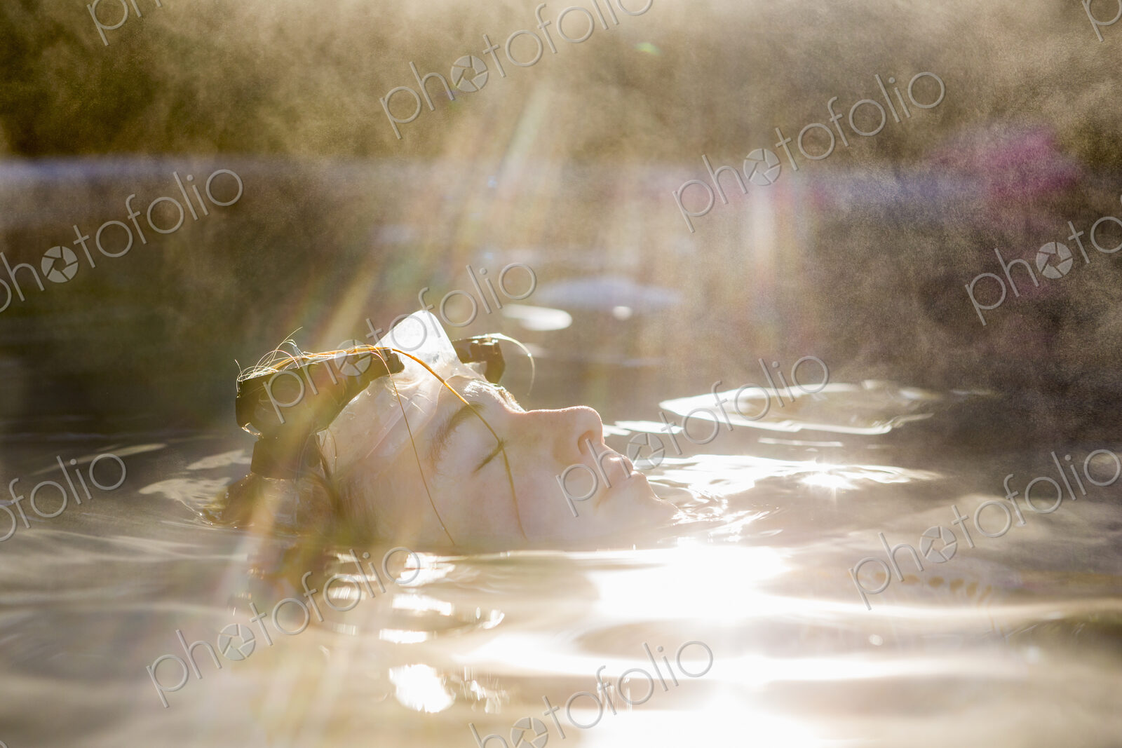 A teenage girl swimming in a pool, steam rising