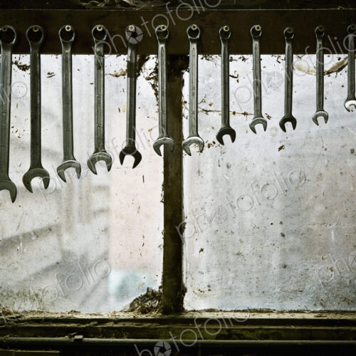 A tool rack with spanners of varying sizes hanging up in order. A tool rack with spanners of varying sizes hanging up in order.