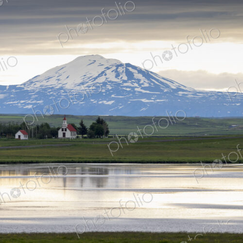 A traditional church on a lake shore in a mountain landscape. A traditional church on a lake shore in a mountain landscape.