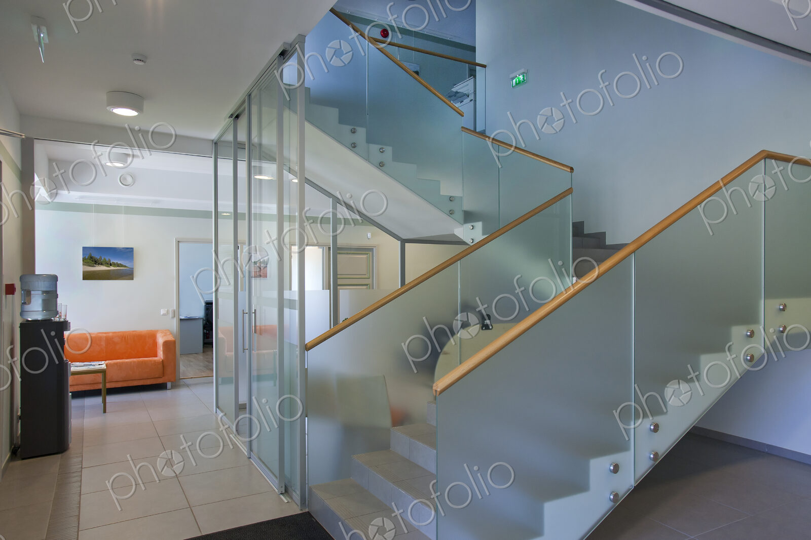 A traditional house with a modern glass extension, two storeys, with glass walls.