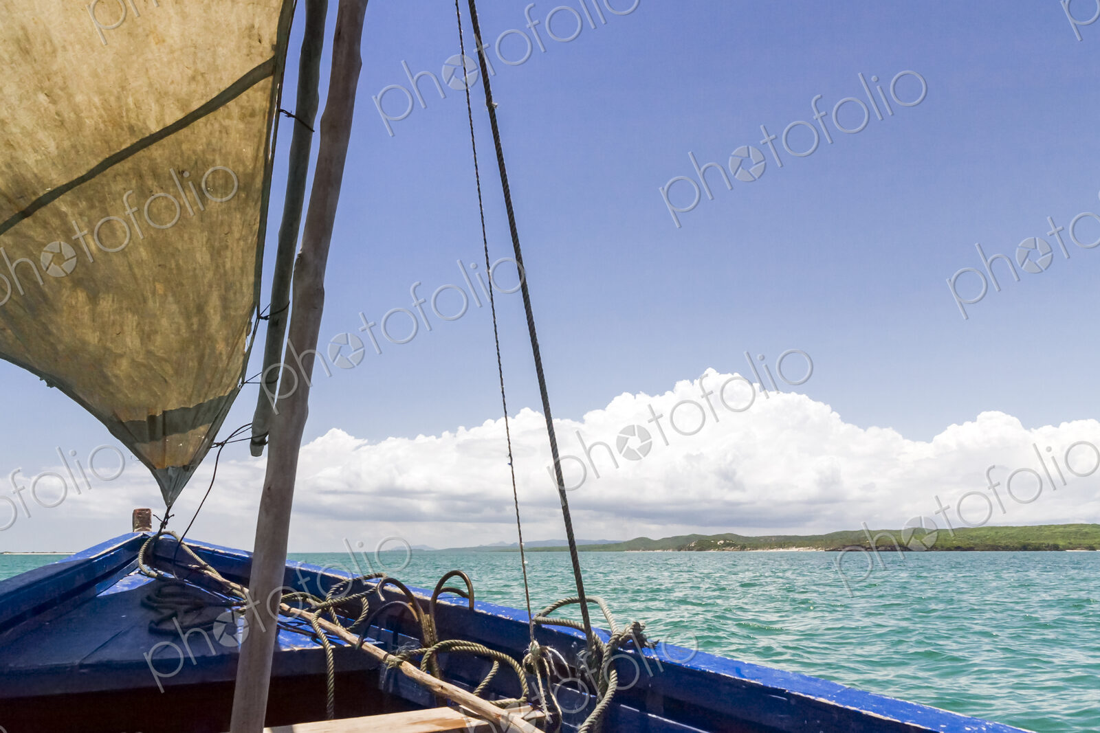A traditional sailing boat with one sail up, on a calm sea in Antsarinana, north…