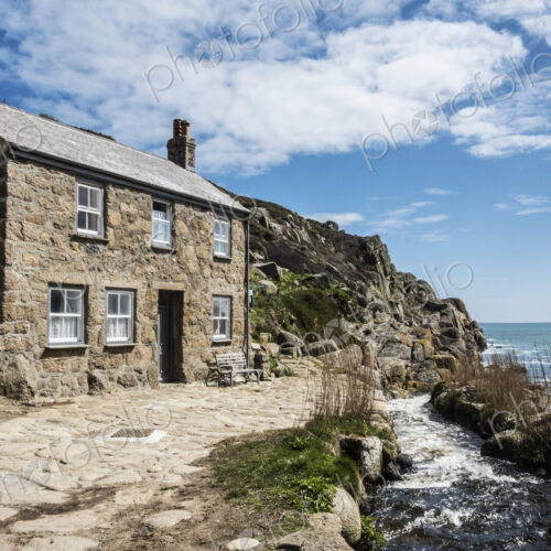 A traditional stone built cottage on the coast, with a path past the front door. A traditional stone built cottage on the coast, with a path past the front door.