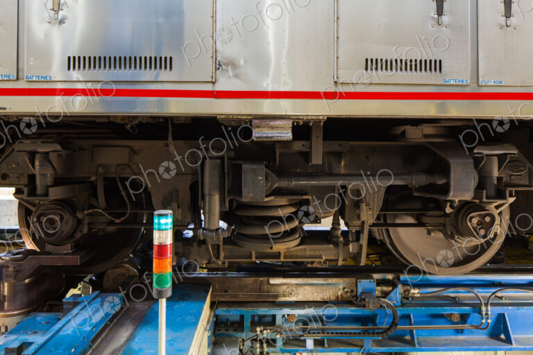 A train, the wheels and low section of a train carriage on rails.