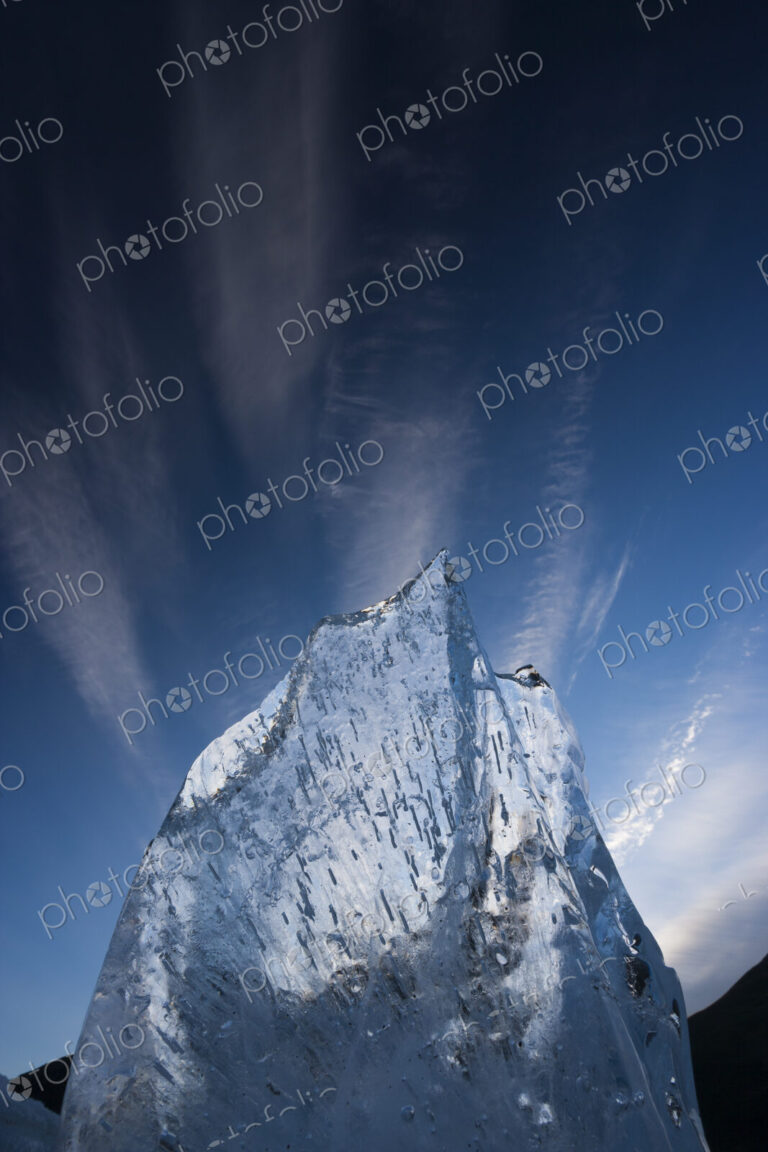A translucent shard of aufeis reaches toward the arctic sky, Arctic National Wildlife…