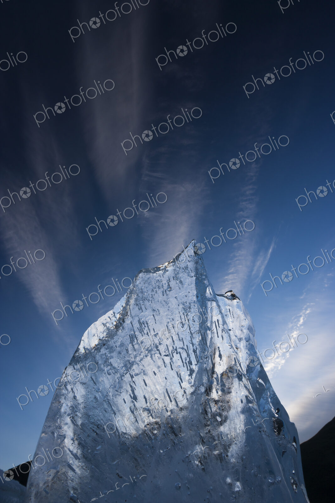 A translucent shard of aufeis reaches toward the arctic sky, Arctic National Wildlife…
