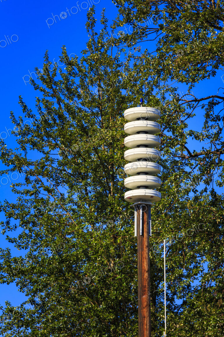 A tsunami alarm installation on Lummi Island among the trees.