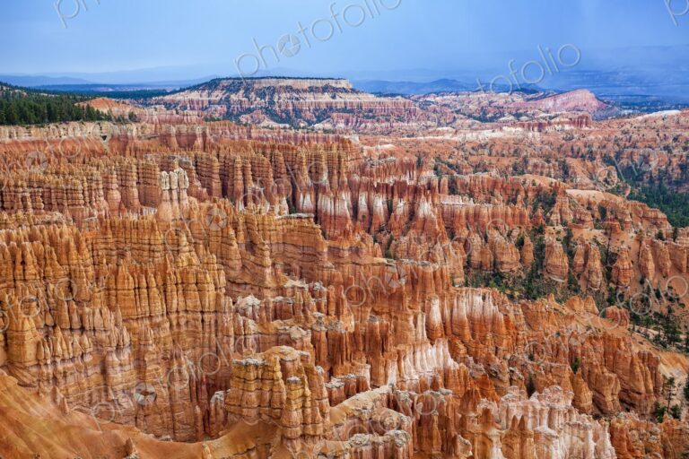 A vibrant maze of hoodoos fills the Bryce Canyon landscape, with rich red and orange…
