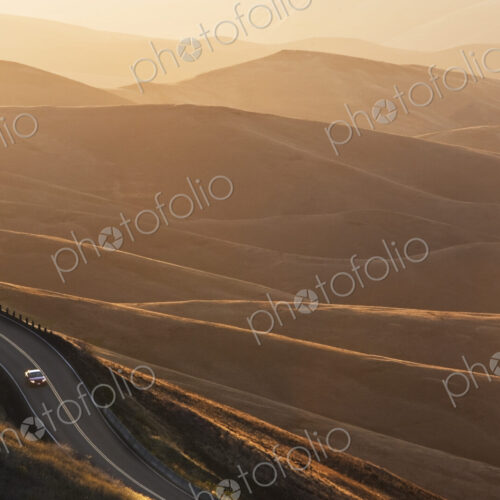 A view looking down of a car moving on a highway at sunrise near Lewiston, Idaho USA.
