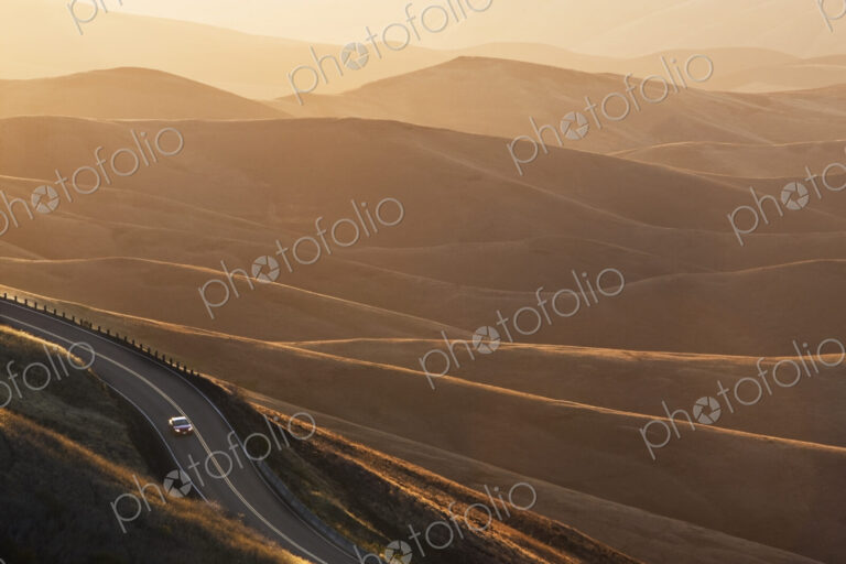 A view looking down of a car moving on a highway at sunrise near Lewiston, Idaho USA.