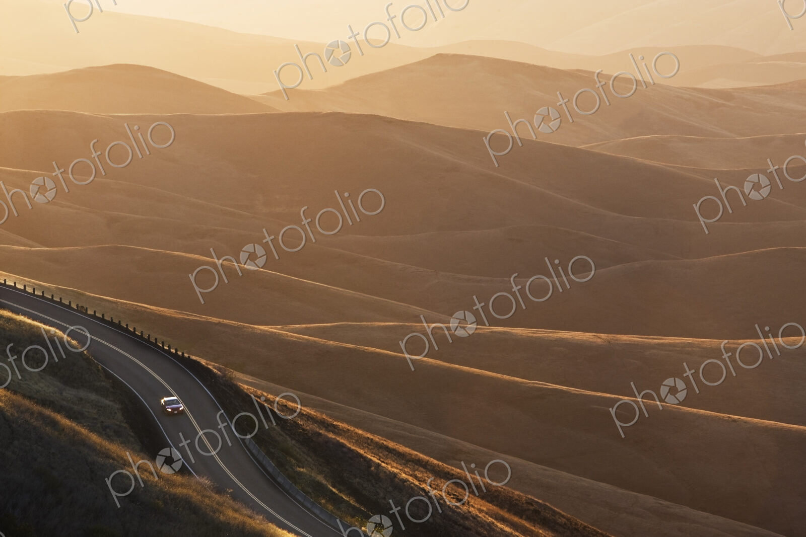 A view looking down of a car moving on a highway at sunrise near Lewiston, Idaho USA.