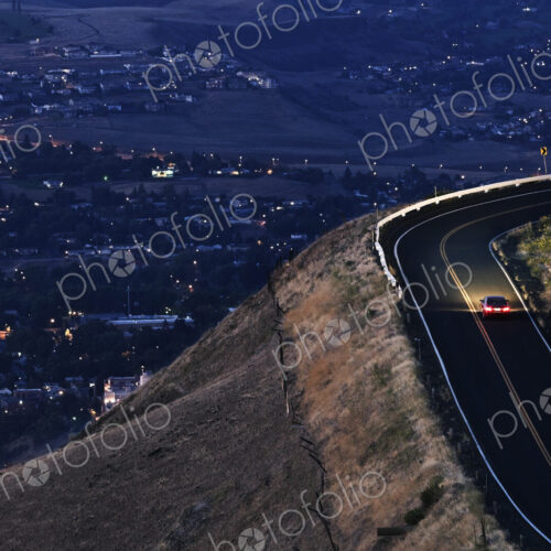 A view looking down on a car moving on a highway almost at dark near Clarkston,… A view looking down on a car moving on a highway almost at dark near Clarkston,…