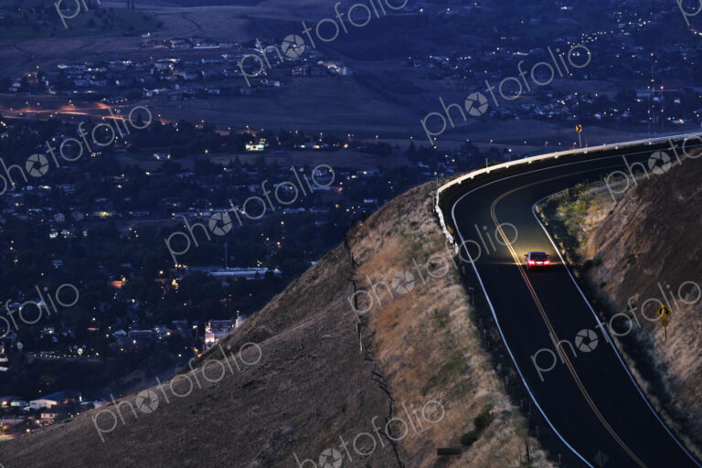 A view looking down on a car moving on a highway almost at dark near Clarkston,…