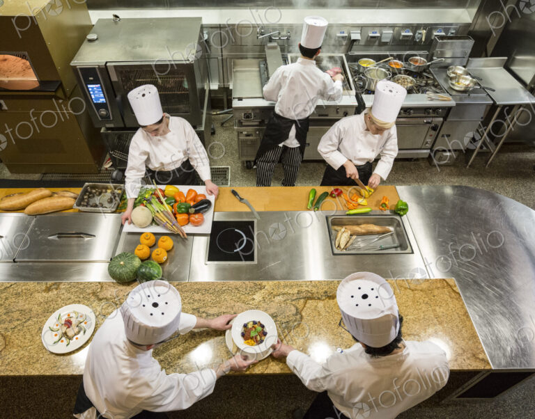 A view looking down on a crew of chefs working in a commercial kitchen,