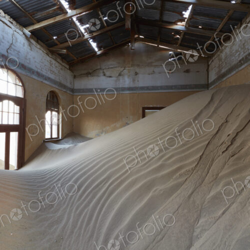 A view of a room in a derelict building full of sand. A view of a room in a derelict building full of sand.