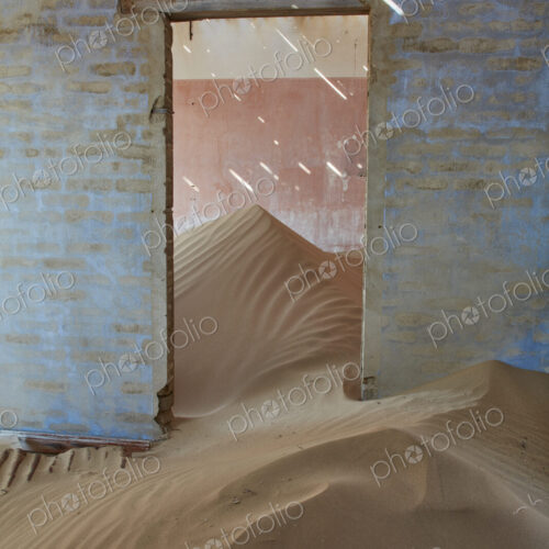A view of a room in a derelict building full of sand. A view of a room in a derelict building full of sand.
