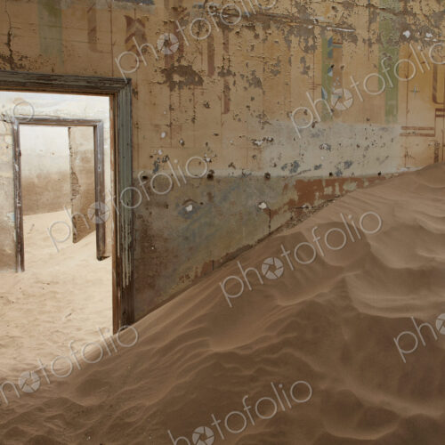 A view of a room in a derelict building full of sand. A view of a room in a derelict building full of sand.