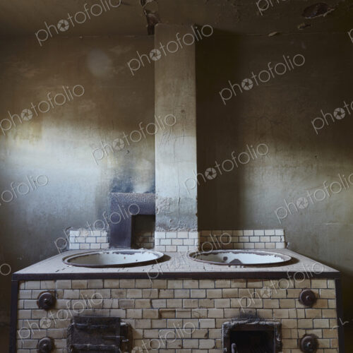 A view of an old fashioned stove in a derelict building. A view of an old fashioned stove in a derelict building.