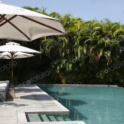 A view of the infinity pool and umbrellas at a hotel.