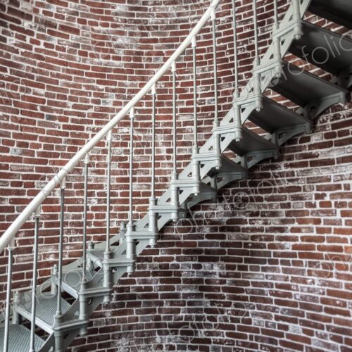 A view of the metal spiral staircase winding up inside the Umpqua Lighthouse in… A view of the metal spiral staircase winding up inside the Umpqua Lighthouse in…