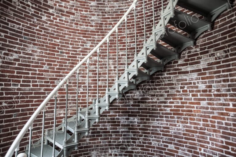 A view of the metal spiral staircase winding up inside the Umpqua Lighthouse in…