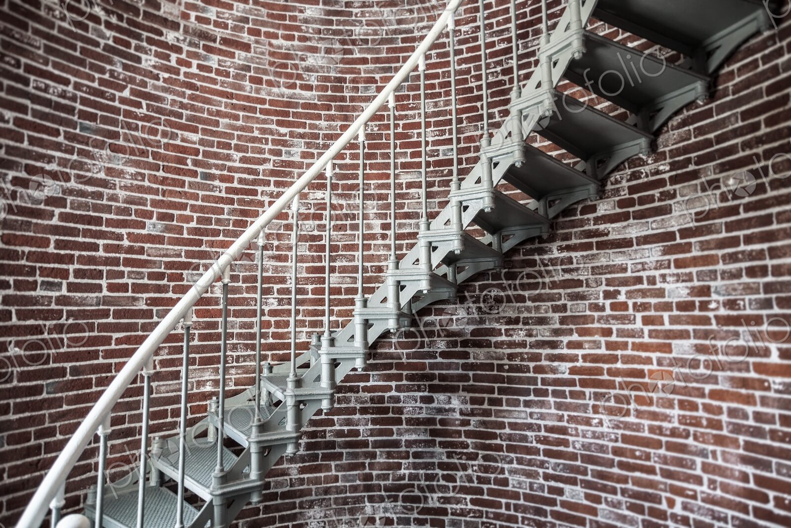 A view of the metal spiral staircase winding up inside the Umpqua Lighthouse in…