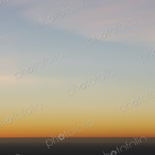 A view over the Pacific Ocean and the sunset on the horizon.