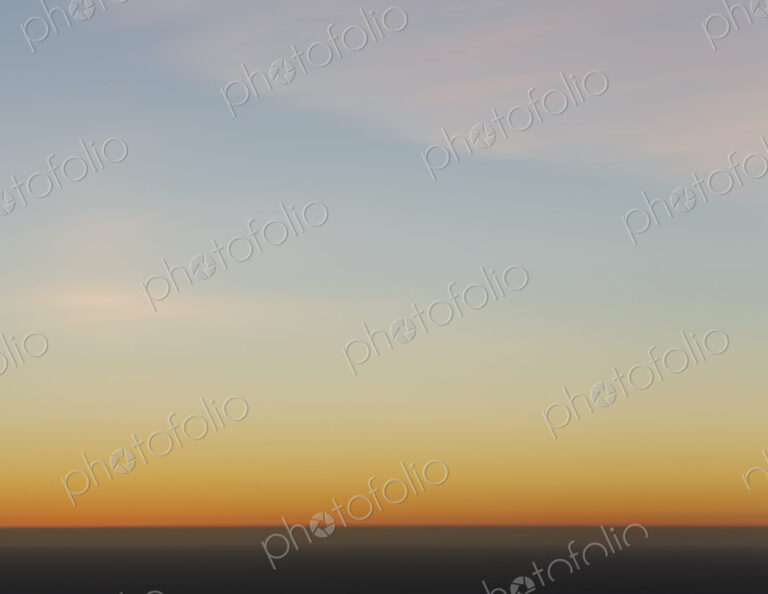 A view over the Pacific Ocean and the sunset on the horizon.