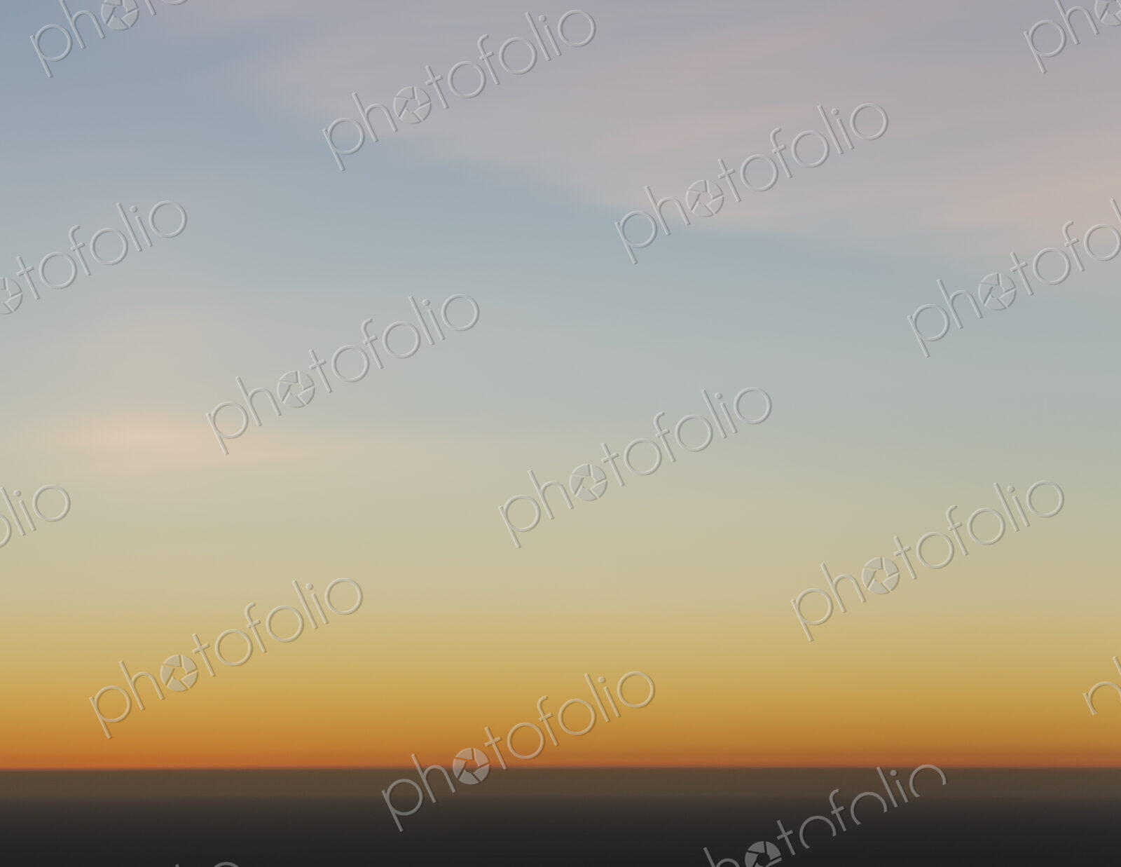 A view over the Pacific Ocean and the sunset on the horizon.