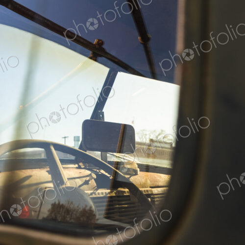 A vintage truck, with a view into the driver's cab.