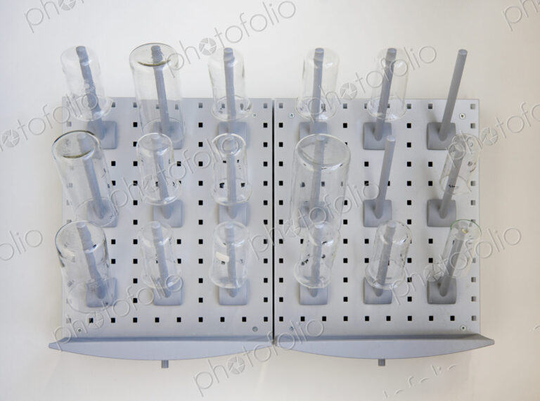 A wall rack of jars and flasks in the Chemistry laboratory at a university chemistry…