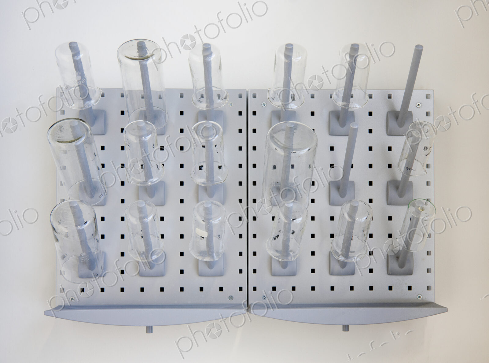 A wall rack of jars and flasks in the Chemistry laboratory at a university chemistry…