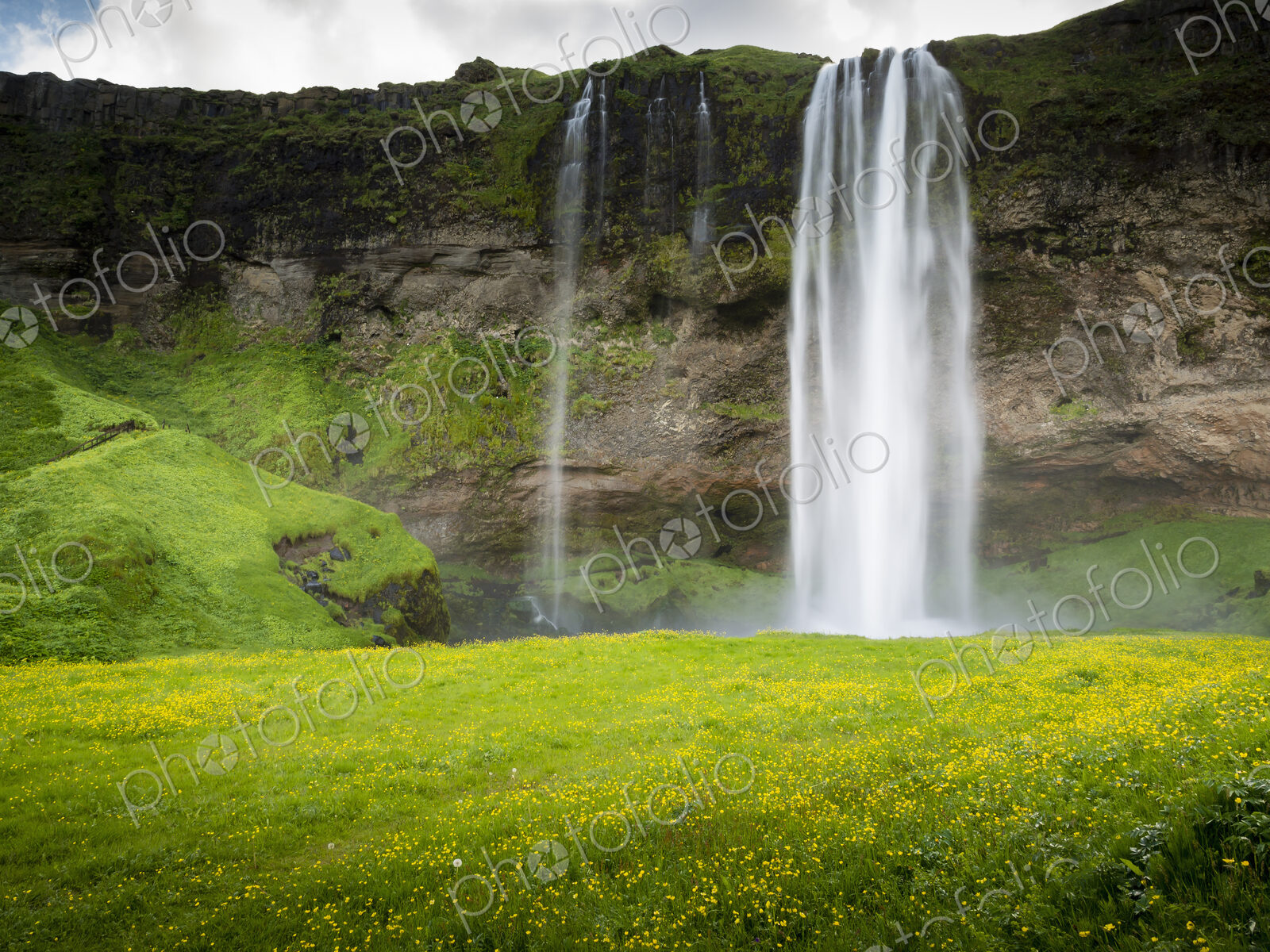A waterfall cascade over a sheer cliff.