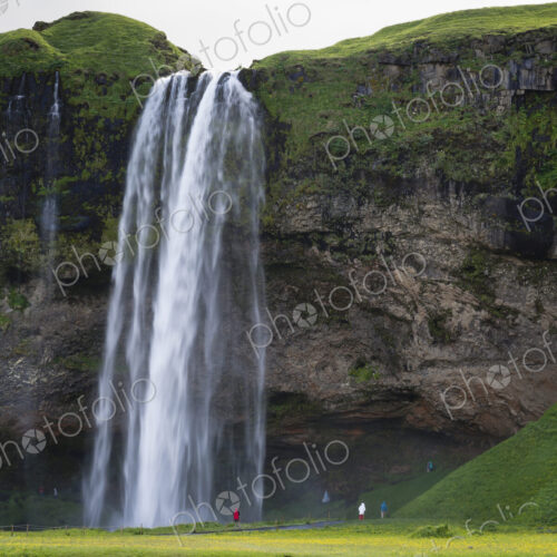 A waterfall cascade over a sheer cliff.